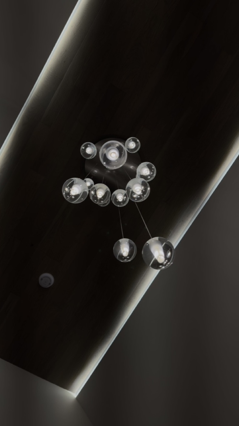 Cluster of clear glass bubble pendants in designer chandelier at Casa TRES