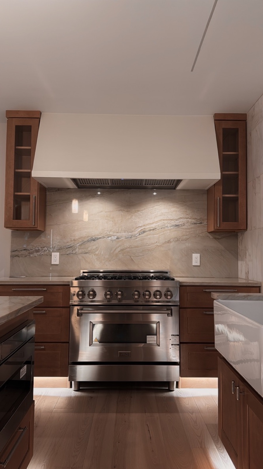 Calacatta marble waterfall backsplash and pro range in Casa TRES kitchen