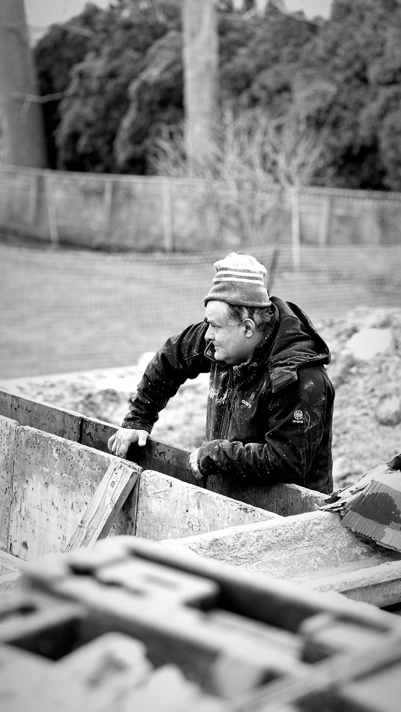 Edwin Cortes at a foundation trench — the patriarch builder