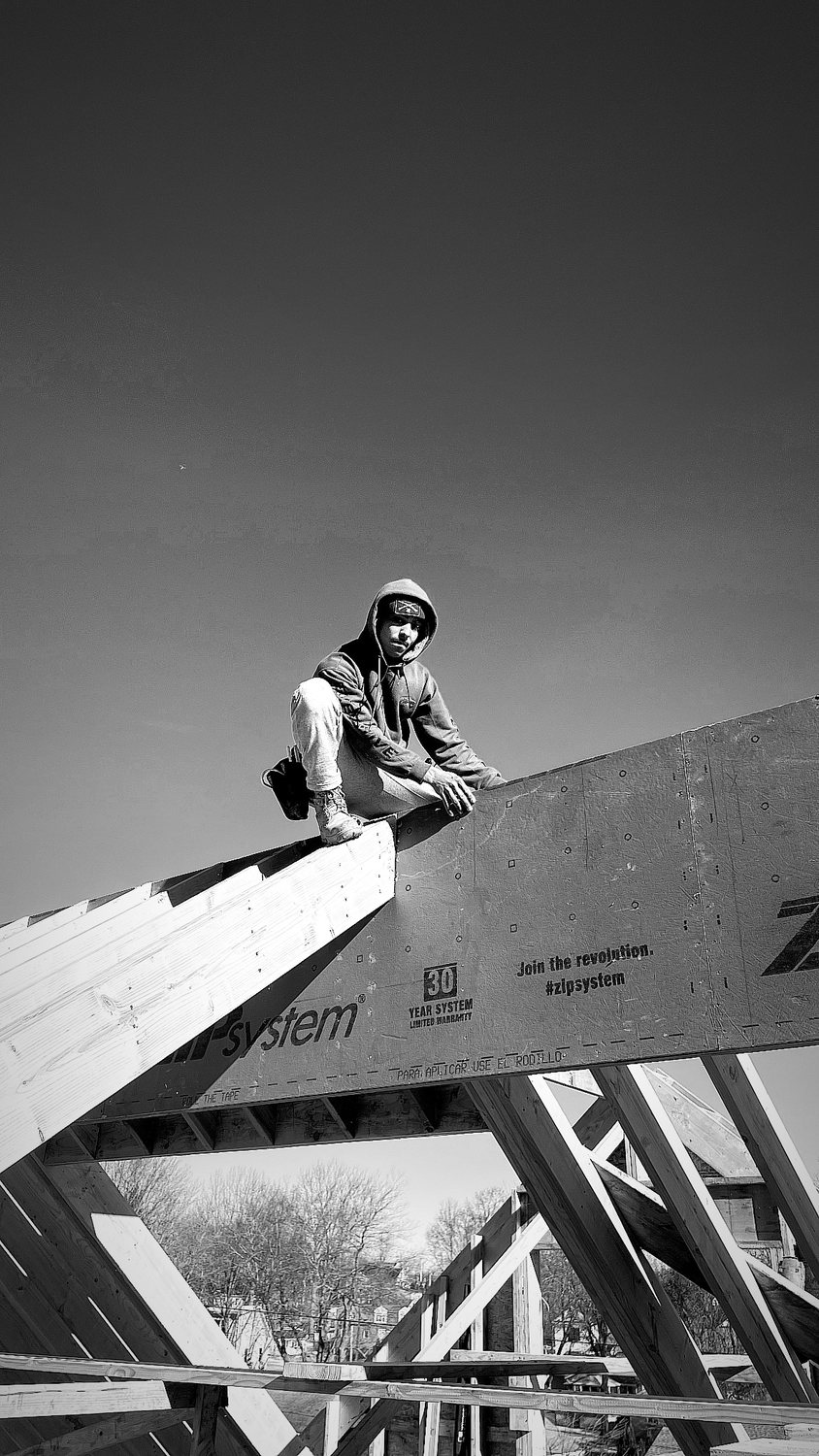 A builder at work on a More Life home, black and white.