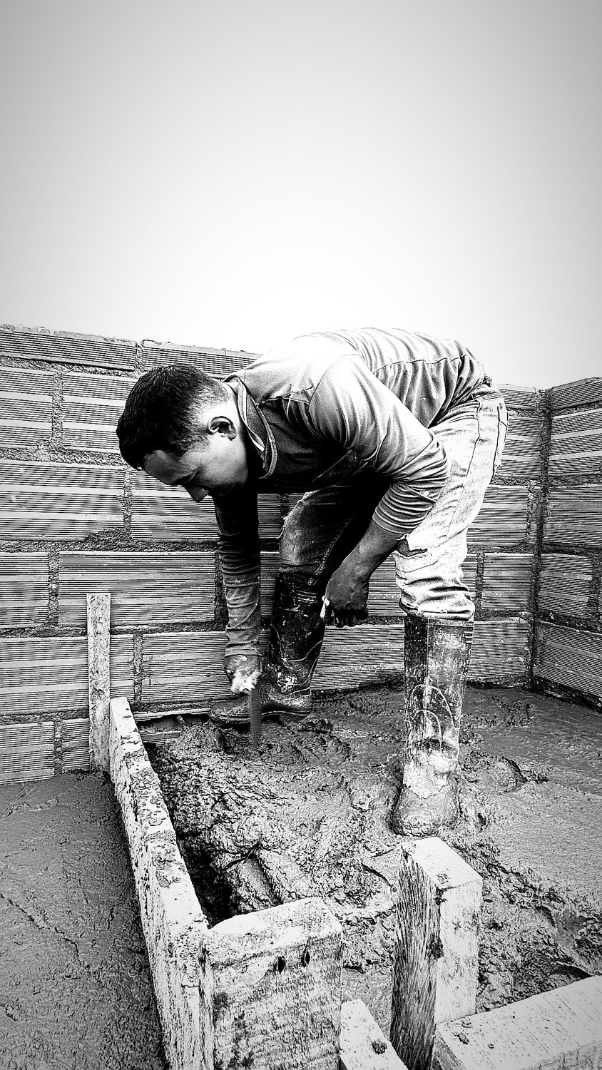 A builder at work on a More Life home, black and white.