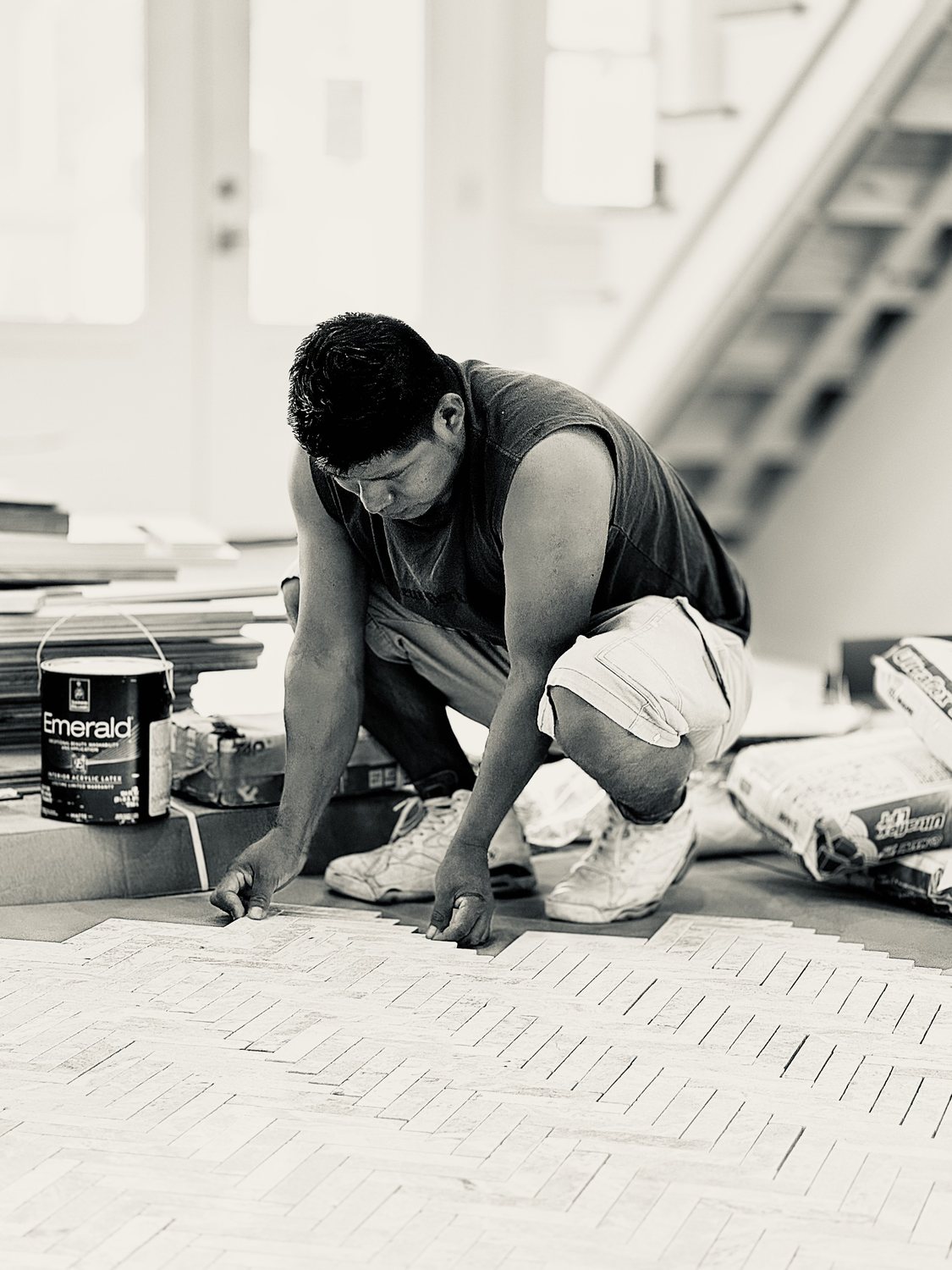 A builder at work on a More Life home, black and white.