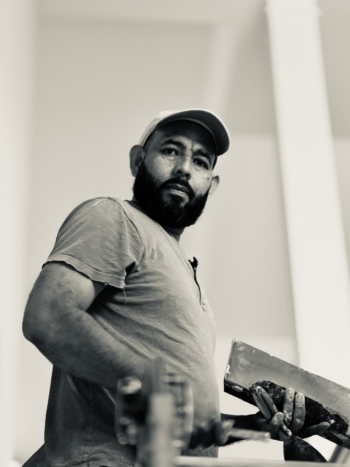 A builder at work on a More Life home, black and white.
