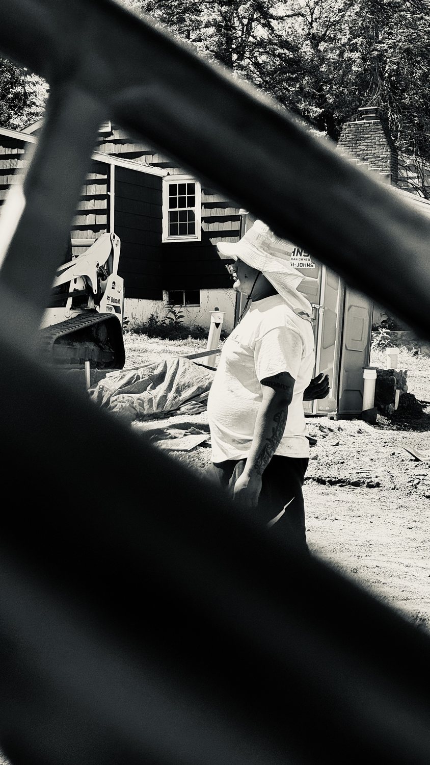 A builder at work on a More Life home, black and white.