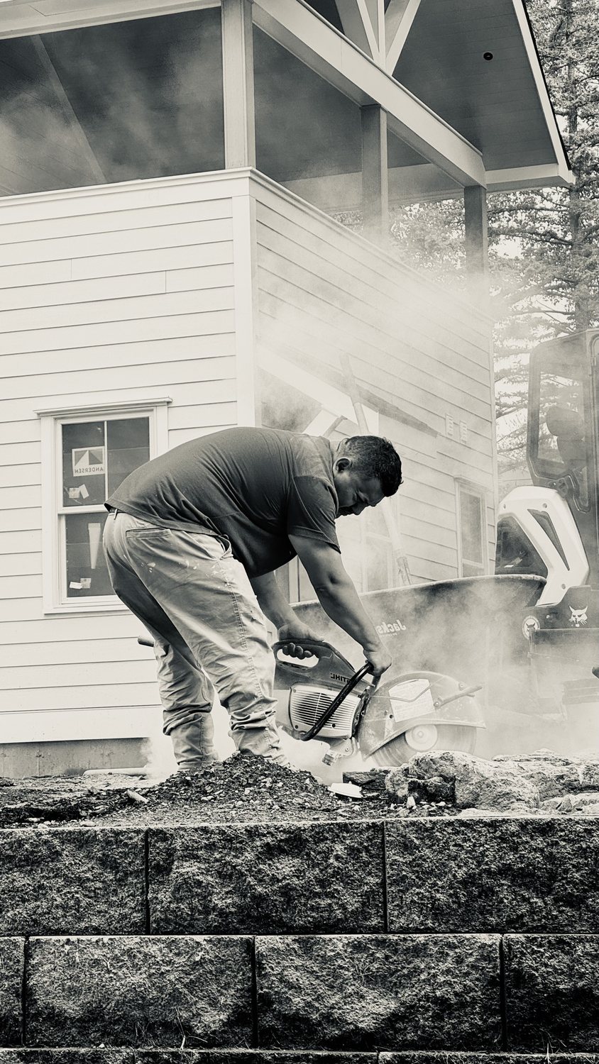 A builder at work on a More Life home, black and white.
