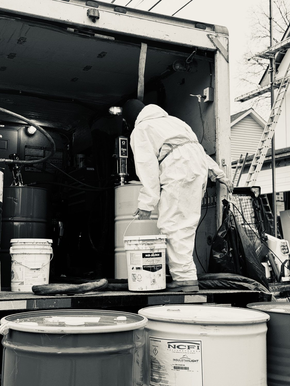 A builder at work on a More Life home, black and white.