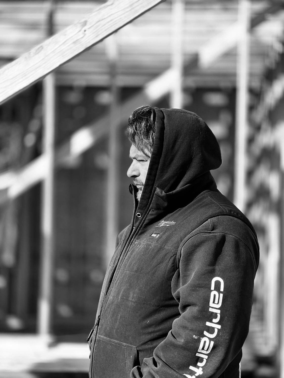 A builder at work on a More Life home, black and white.