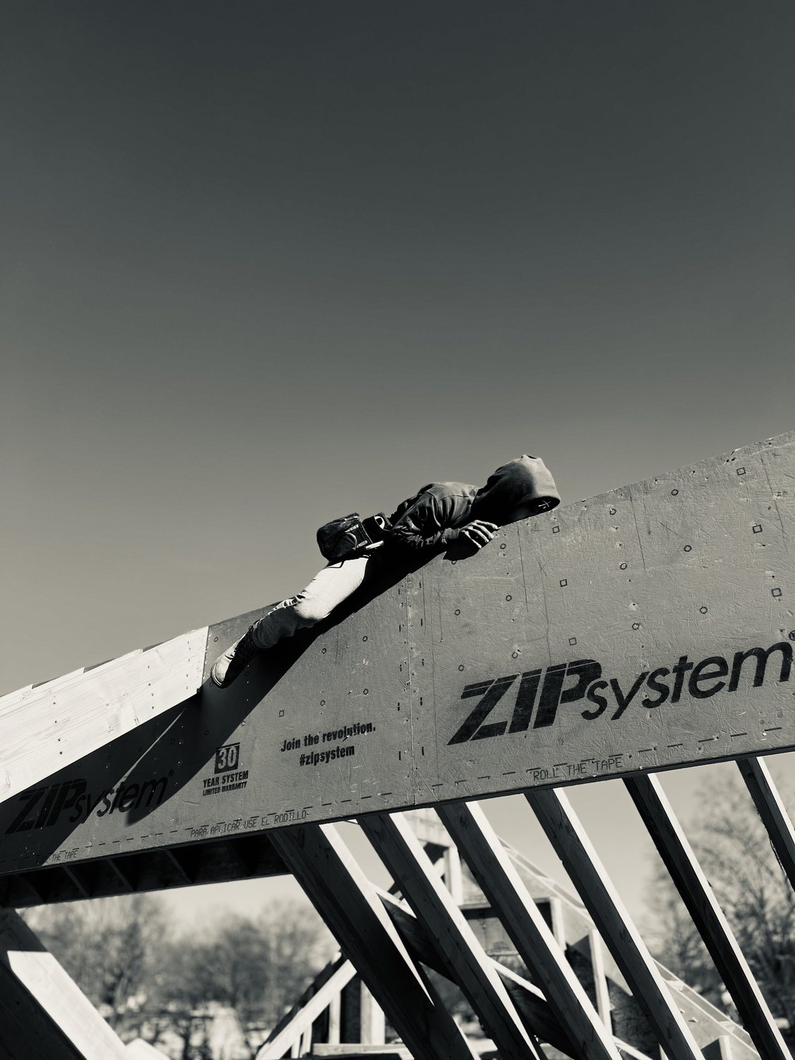 A builder at work on a More Life home, black and white.
