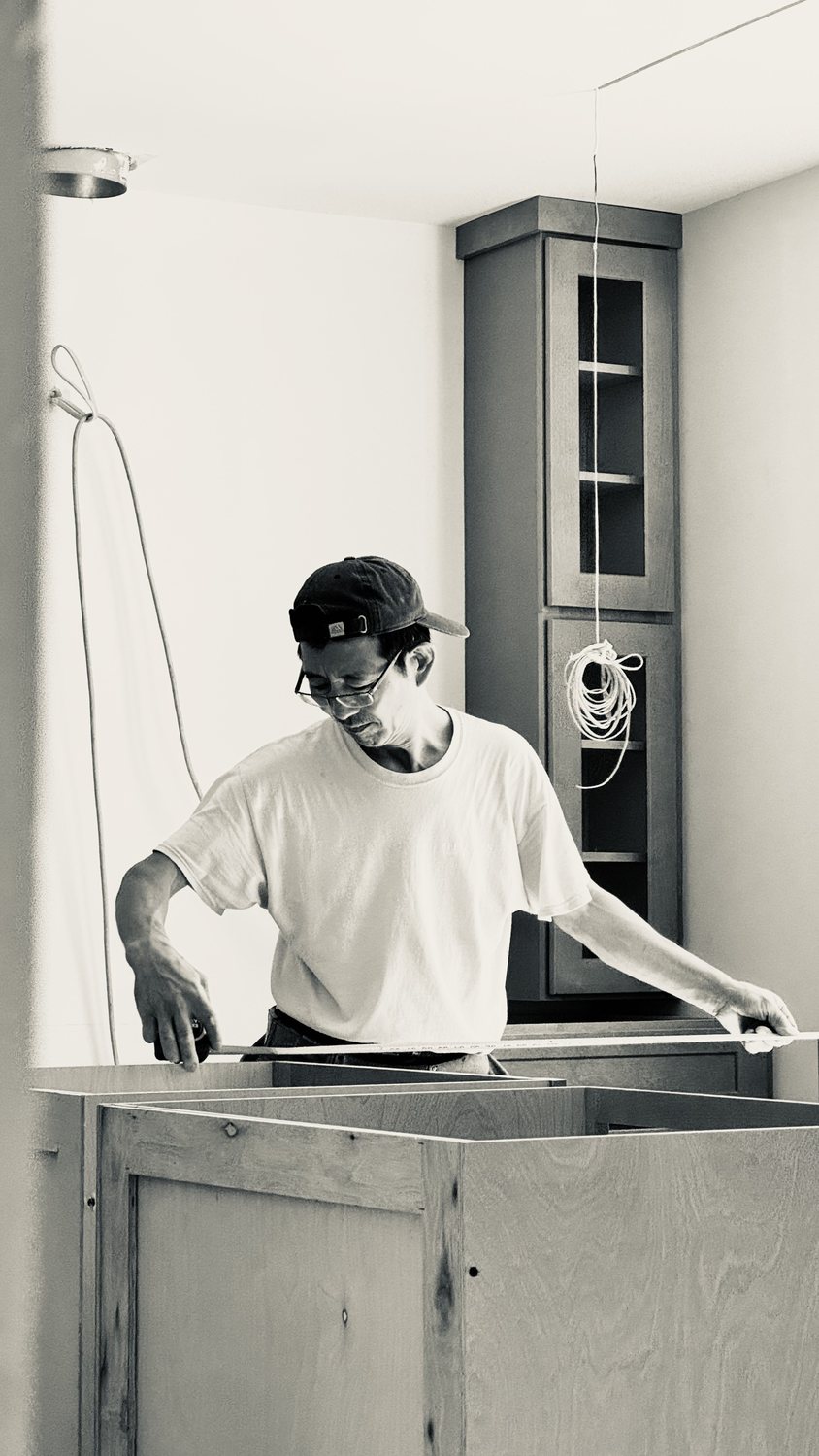 A builder at work on a More Life home, black and white.
