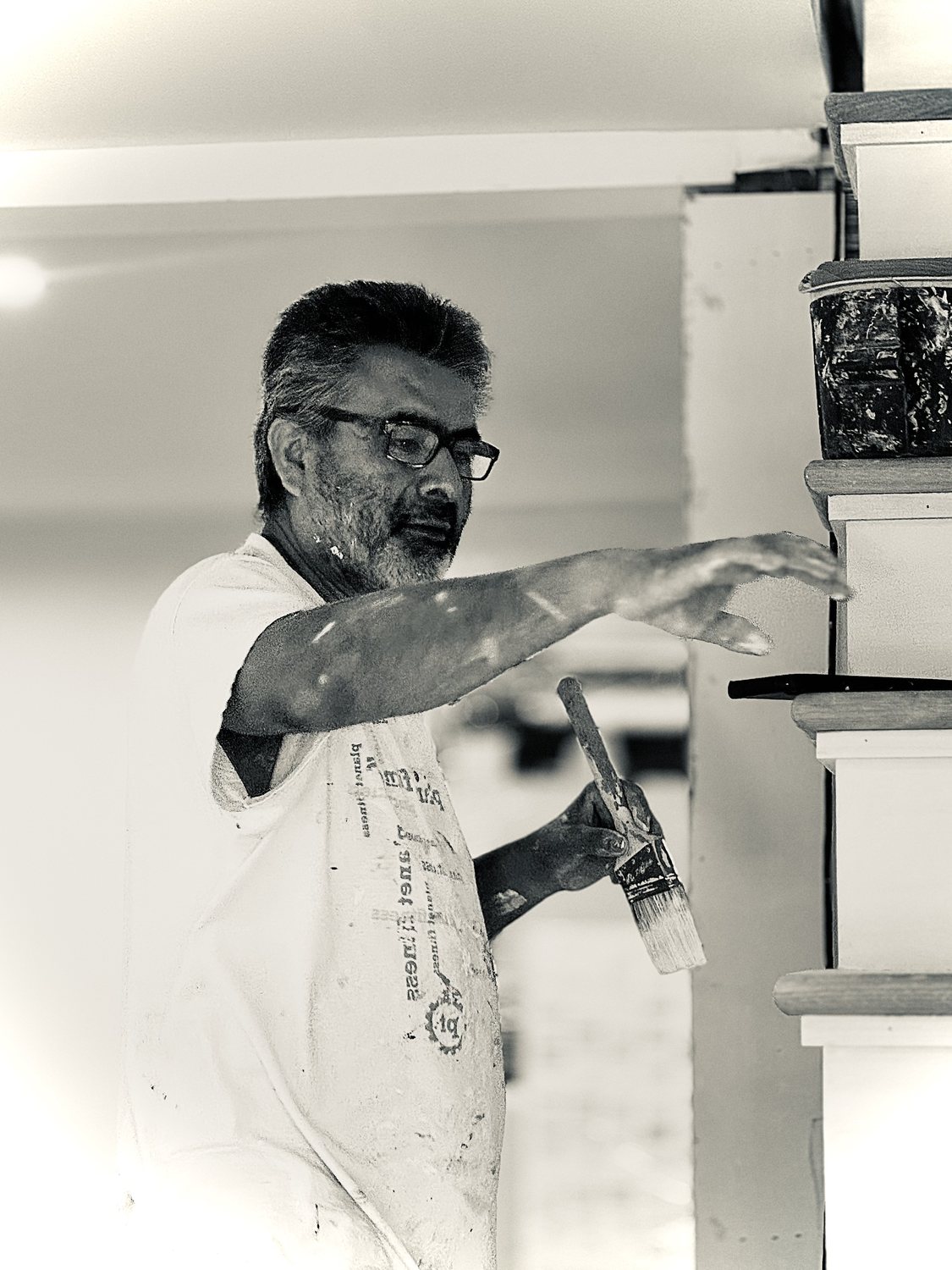 A builder at work on a More Life home, black and white.
