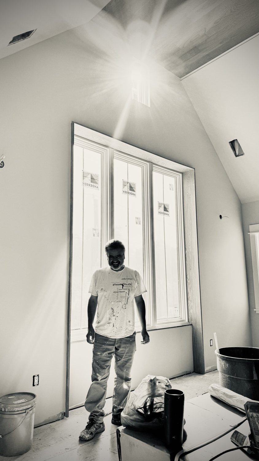 A builder at work on a More Life home, black and white.